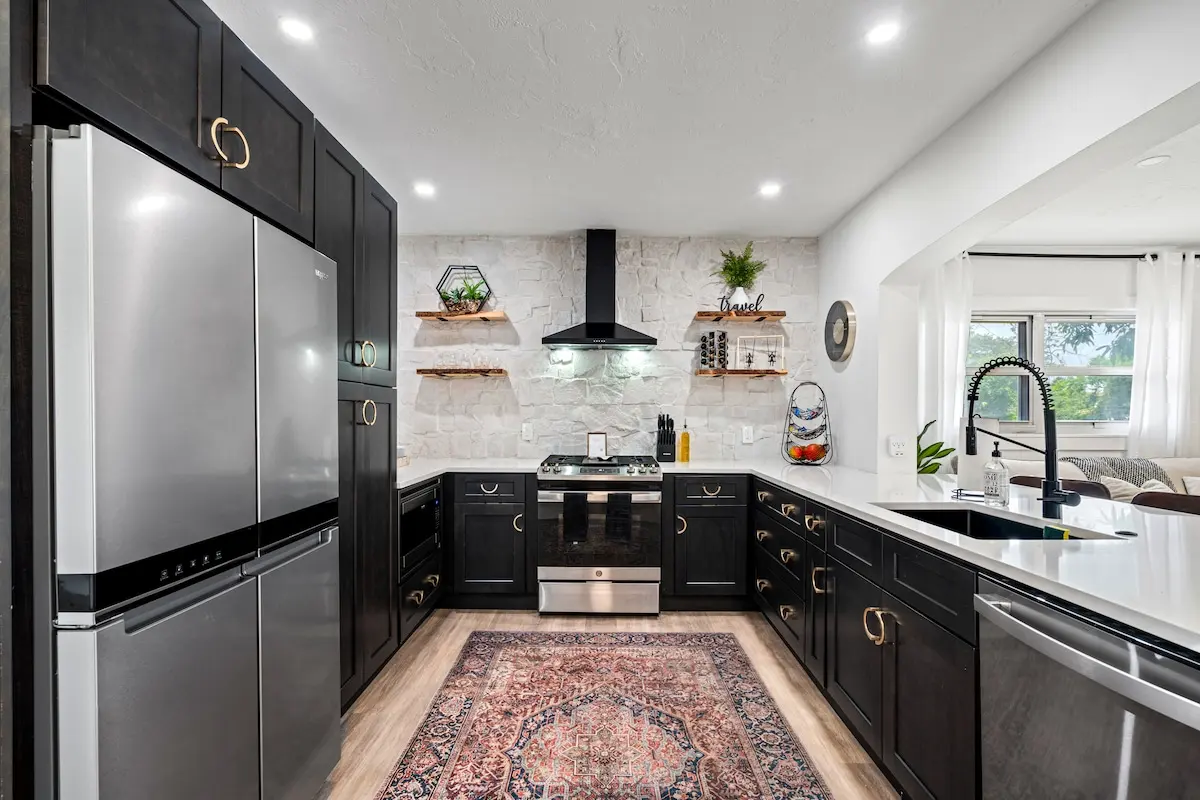 Kitchen with black cabinetry and gold accents