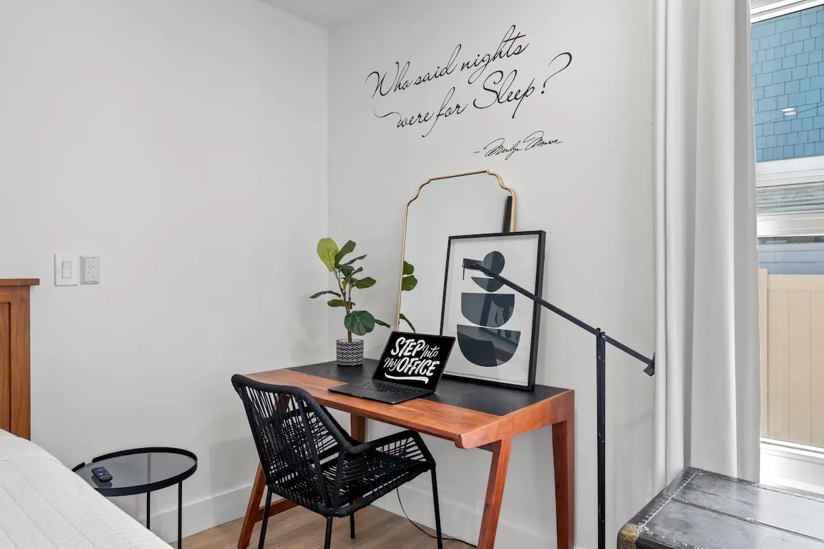 Step into your office (even on vacation). This bright workspace is ready for emails, journaling, or planning your next beach day — all under Marilyn’s watchful eye.